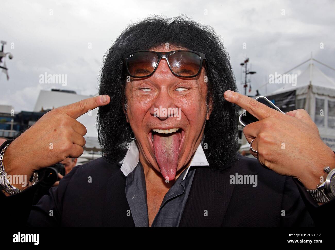 Musician Gene Simmons of the rock band Kiss sticks out his tongue as he  poses during a photocall for the television reality singing competition  show "Coliseum" during the annual MIPCOM television programme