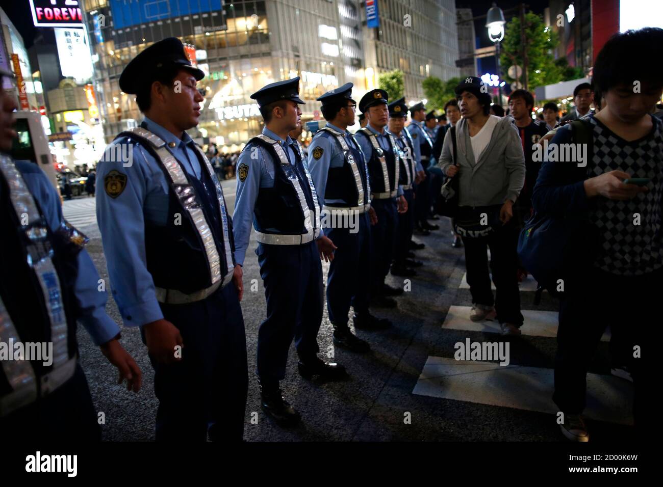 Police Officers Try To Control Japanese Soccer Fans And Pedestrians As They Celebrate Japan S Qualification For The World Cup Finals In Brazil After The 14 World Cup Qualifying Soccer Match Against Australia Police Officers Try To Control Japanese Soccer Fans And Pedestrians As They Celebrate Japan S Qualification For The World Cup Finals In Brazil After The 14 World Cup Qualifying Soccer Match Against Australia