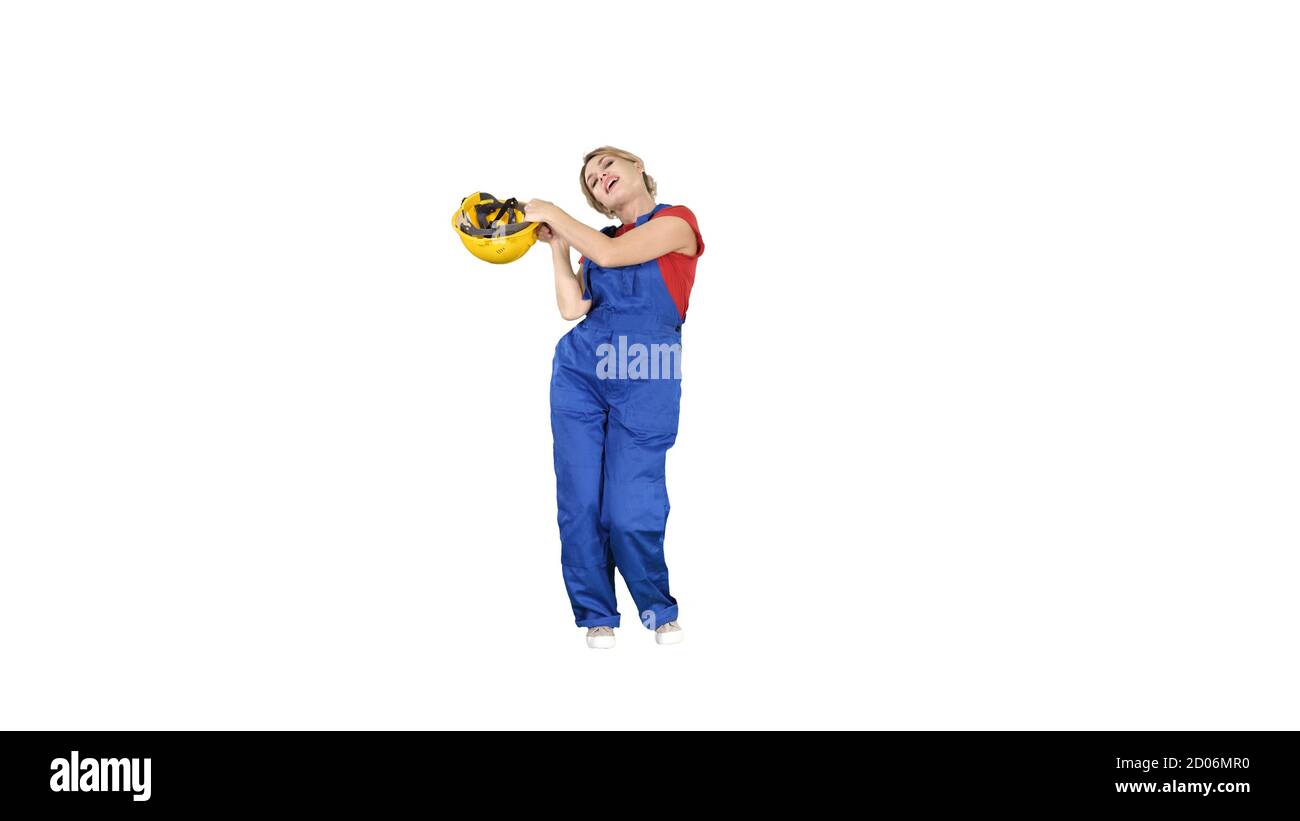 Tradeswoman bailando uniforme de la construcción mujer vestida en blanco Foto de stock