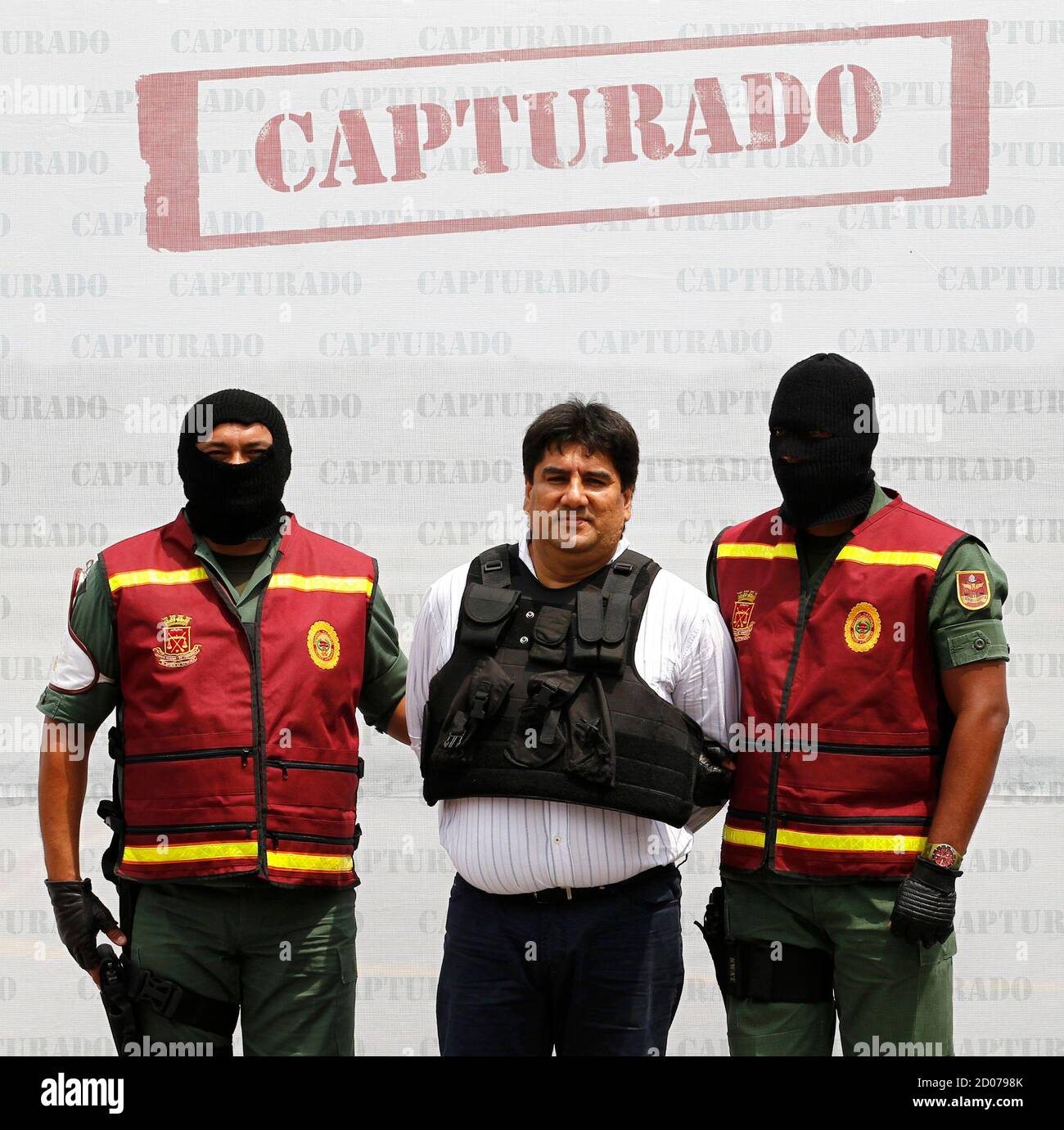 Suspected Colombian drug trafficker Jaime Alberto Marin Zamora, also known  as "Beto Marin", is escorted by police officers during his extradition to  the U.S. at Simon Bolivar Airport, outside Caracas, September 20,
