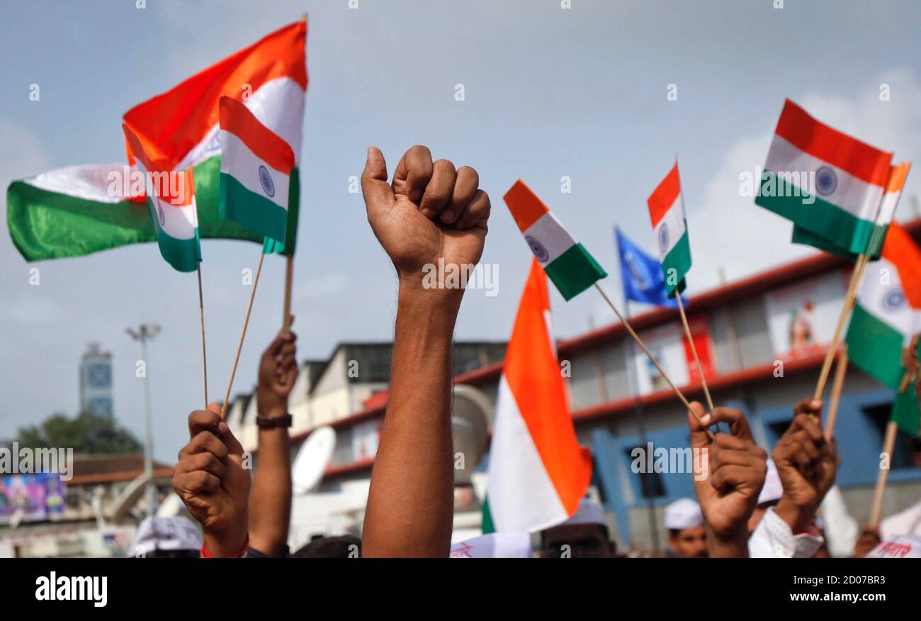 Los partidarios de la veterana activista social India Anna Hazare levantan banderas nacionales indias durante una manifestación de protesta contra la corrupción en Mumbai el 16 de agosto de 2011. La policía arrestó a Hazare el martes, pocas horas antes de que comenzara un ayuno a la muerte, mientras el gobierno atribulado se esforcejaba contra un activista gandhiano de estilo propio que agitaba por una nueva lucha por la 'libertad'. REUTERS/Danés Siddiqui (INDIA - Tags: POLÍTICA DISTURBIOS CIVILES) Foto de stock