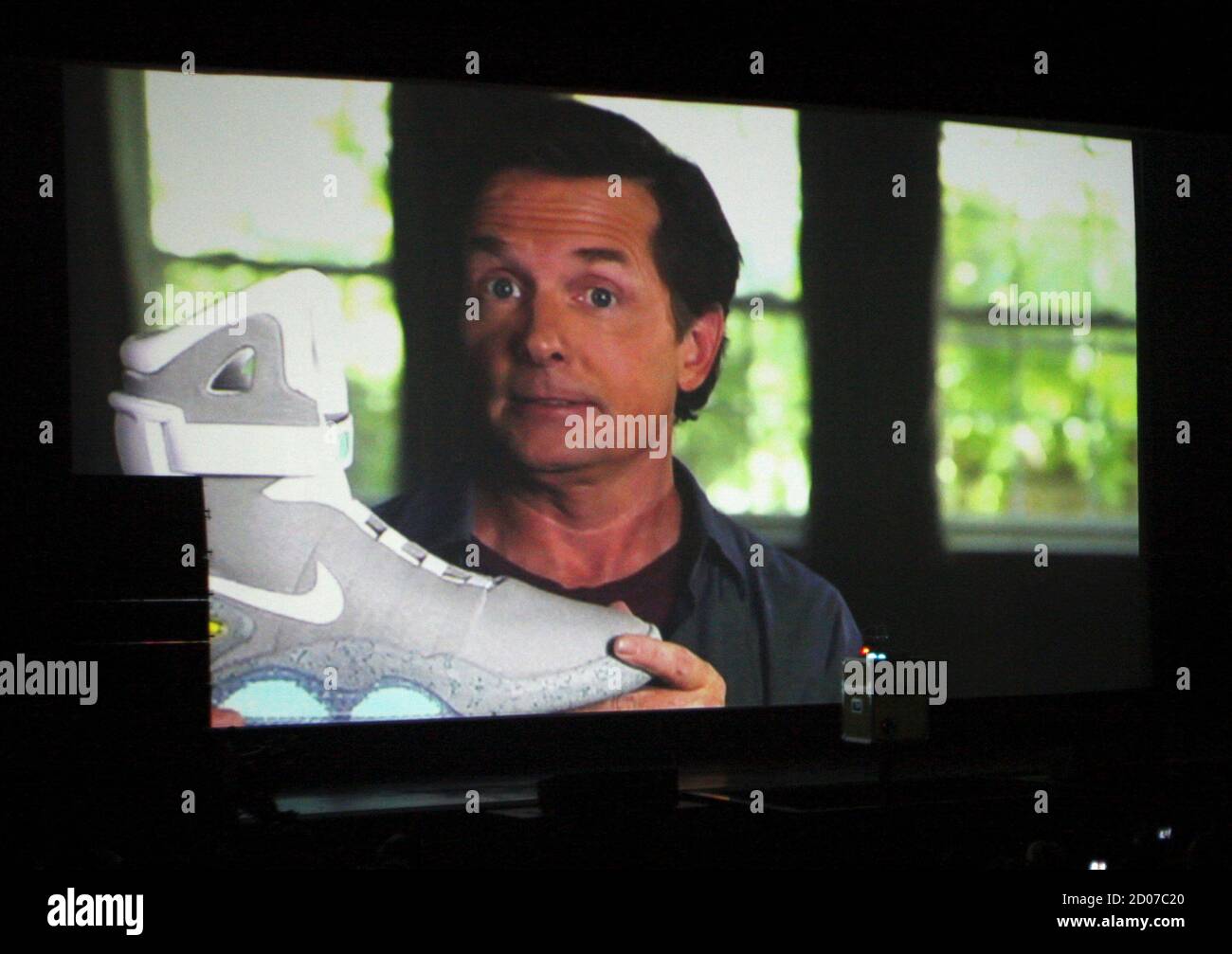 inquilino pobre Compulsión Actor Michael J. Fox is seen on a screen during a video message holding a  2011 NIKE MAG shoe, based on the original NIKE MAG worn in 2015 by his  "Back to