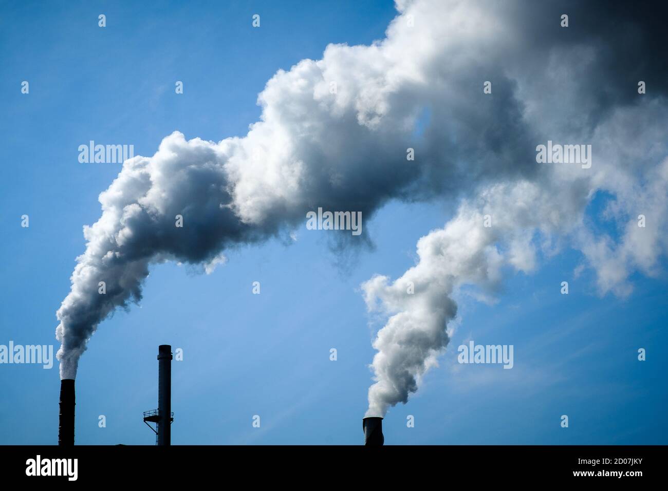 Nubes de contaminación del aire por humo industrial y cielo azul Foto de stock