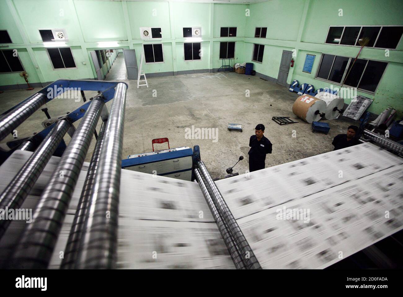 Employees work on a machine printing New Light of Myanmar at newspaper's  office in Naypyitaw September 19, 2012. Established in 1993, the state-run  New Light of Myanmar is the country's only English-language