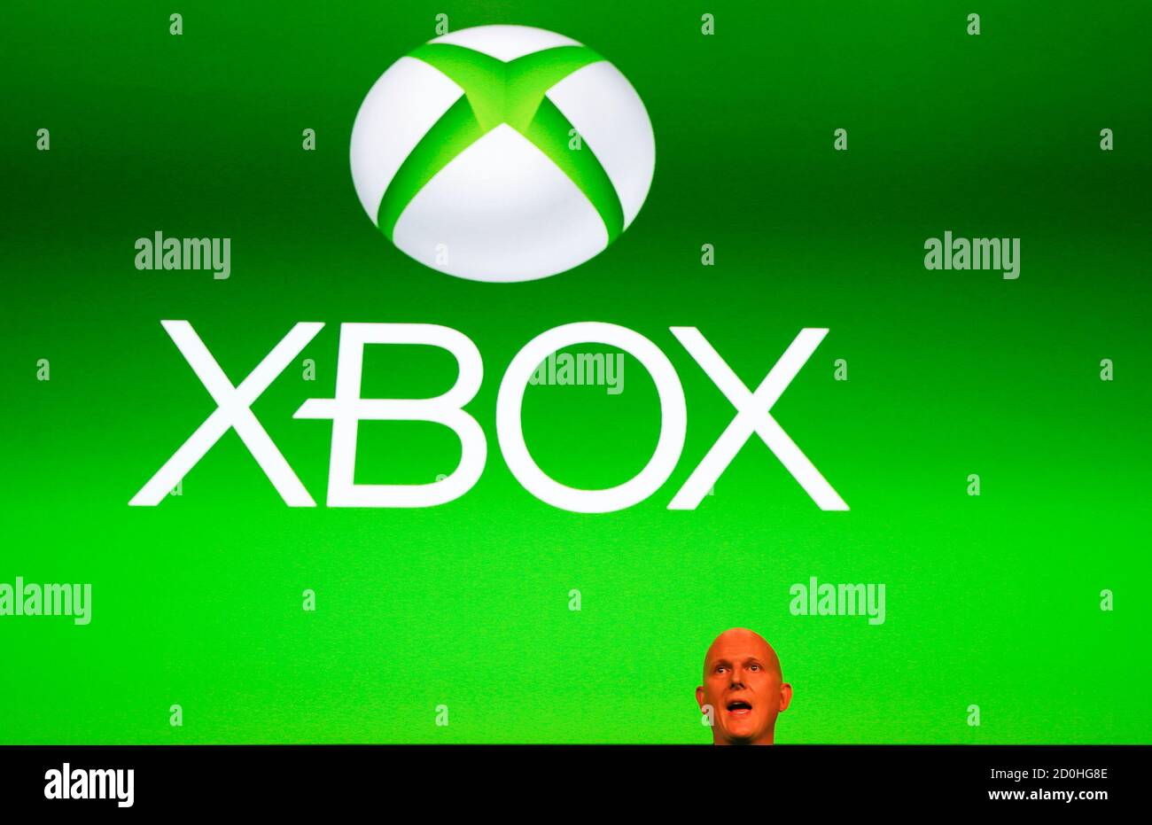 Phil Harrison, corporate vice president of Microsoft, stands in front of a  Xbox logo during the Xbox Play Day 2014, before the Gamescom 2014 fair in  Cologne August 12, 2014. The Gamescom