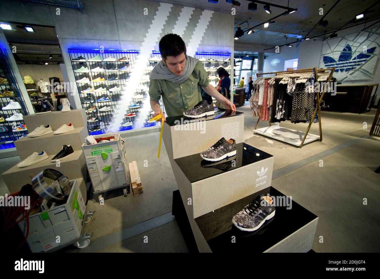 A worker prepares for opening at the new Adidas Originals store in Berlin March 27, 2014. Adidas has launched a new store blueprint for its Originals fashion brand with a Wi-Fi