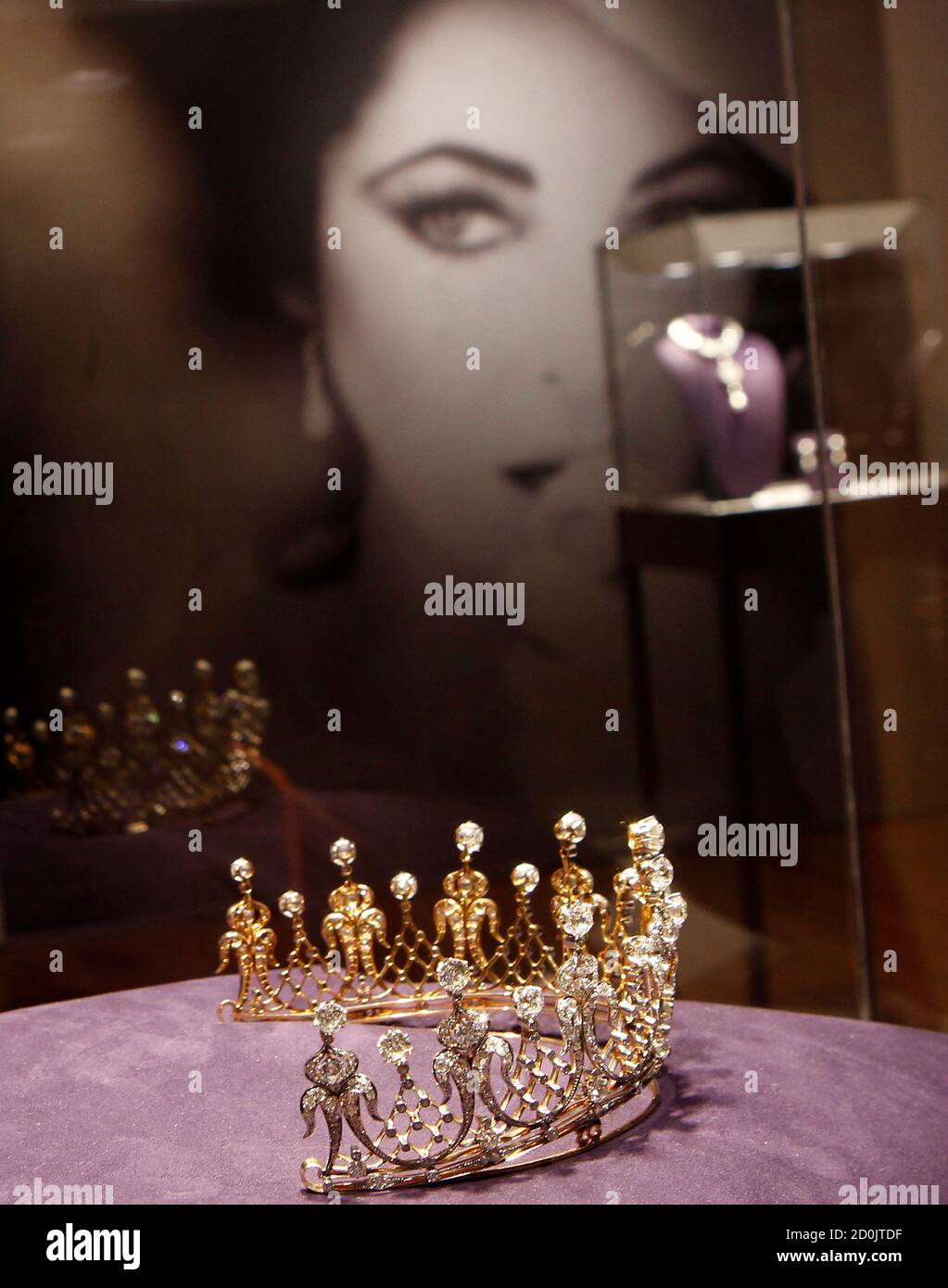 A photograph of Elizabeth Taylor is seen behind jewels on display as part  of the upcoming auction of the late actress' jewelry, clothing, art and  memorabilia at Christie's Auction house in New
