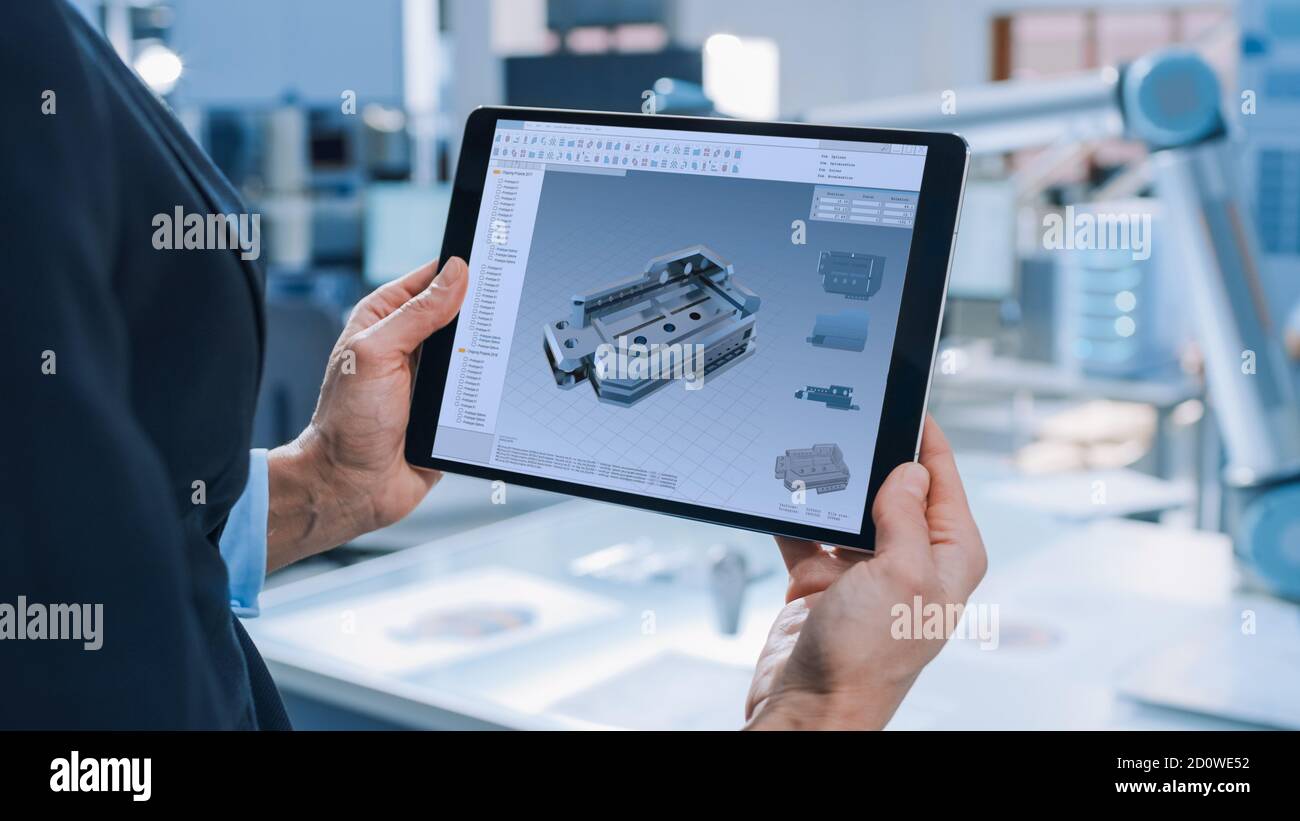 Elegante Ingeniero de Robótica Industrial utiliza Tablet PC con software  CAD y para manipular y programar el brazo del robot para levantar objetos  en movimiento Fotografía de stock - Alamy