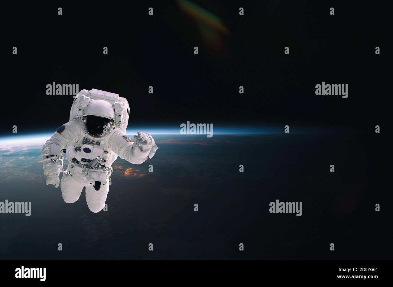 Astronauta caminando en el espacio con fondo terrestre, con llamarada. Elementos de esta imagen proporcionados por la NASA. Foto de stock