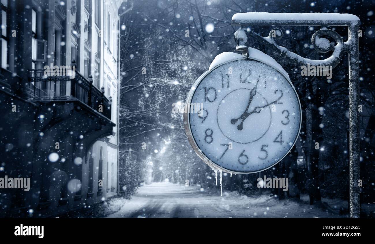 Reloj de calle en invierno. Cambiar a la hora de invierno Foto de stock