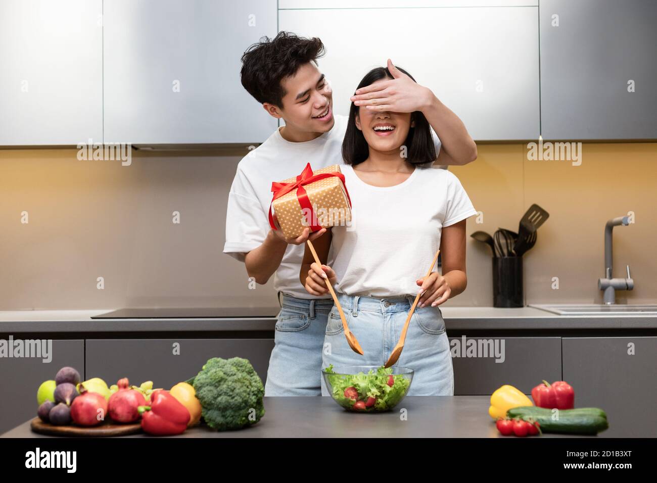 Marido asiático preparando Regalo sorpresa para la esposa de pie en la  cocina Fotografía de stock - Alamy