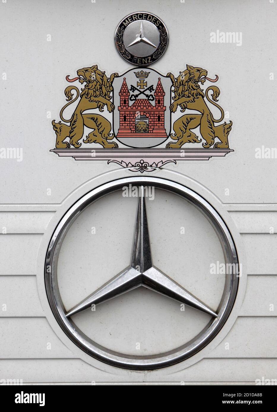 A Mercedes trademark and the Riga city logo are seen on a public bus in  Riga March 26, 2010. Car and truck manufacturer Daimler AG allegedly earned  $1.9 billion in revenue and