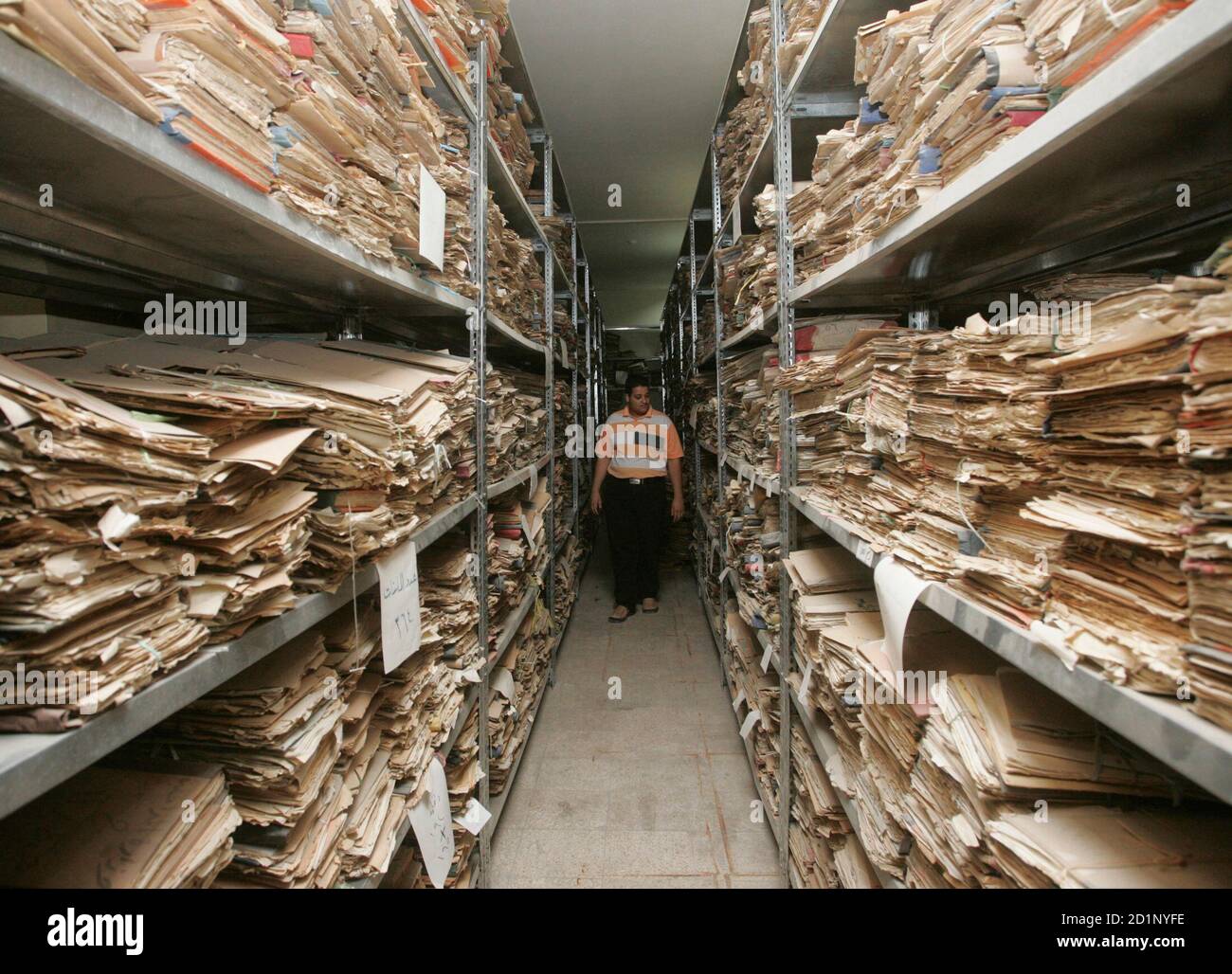 A man walks between the shelves containing historical documents in Iraq's  National library in Baghdad August 12, 2007. Saad Eskander, Director of the  National Library and Archive said on Saturday he feared