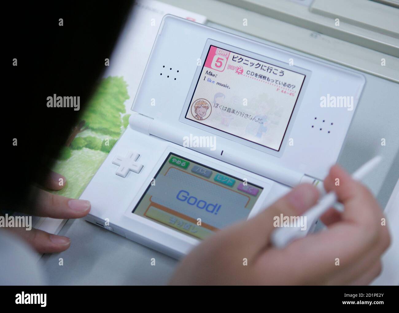 A student uses English language learning software on a Nintendo DS during a  media event at Tokyo Girls Junior High School in Tokyo June 26, 2008. The  school has been using DS