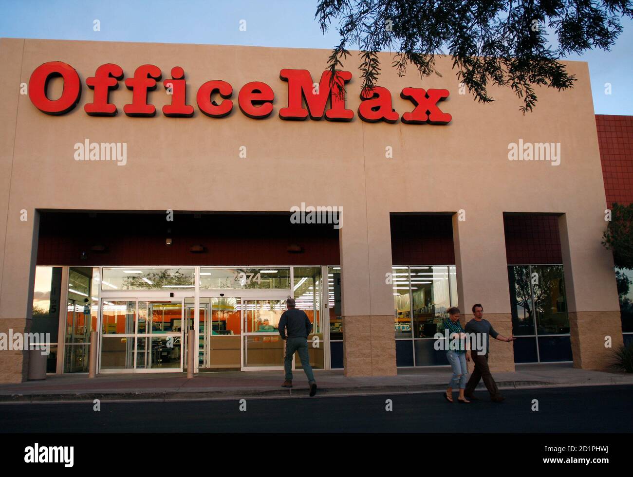 Customers enter and leave the Office Max store in Glendale, Arizona October  28, 2009. Office Depot Inc and OfficeMax Inc reported lackluster  third-quarter sales as both shoppers and corporate customers kept a