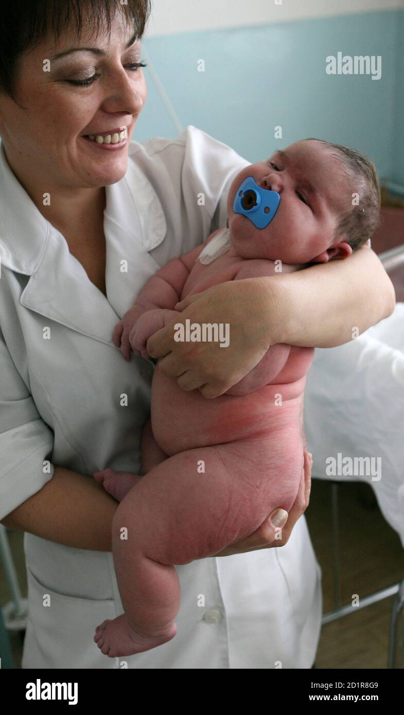 La niña Nadia, que pesó 7.75 kg (17.1 libras) después del nacimiento, es vista en una sala de maternidad en la ciudad siberiana de Barnaul el 26 de septiembre de 2007. Una madre siberiana ha hecho más que su parte justa para curar el terrible declive de la población de Rusia. Tatyana Khalina sorprendió a su marido dando a luz a una niña de 7.75 kg (17.1 libras) este mes, su duodécimo hijo. Foto tomada el 26 de septiembre de 2007. REUTERS/Andrey Kasprishin Foto de stock