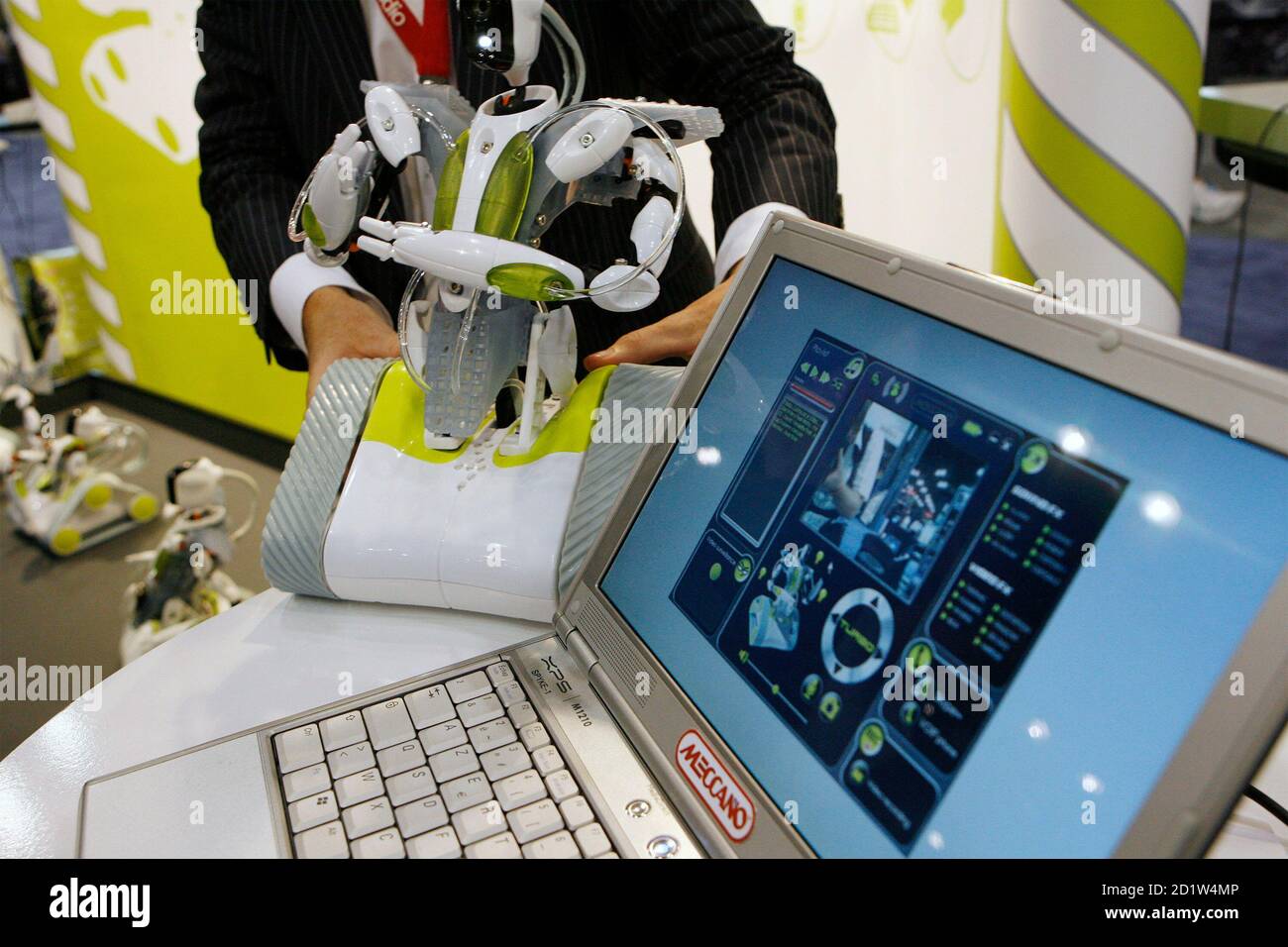 An Erector company representative picks up a "Spykee" robot (L) which is  controlled over a WiFi internet connection during the DigitalLife consumer  electronics show in New York September 27, 2007. REUTERS/Lucas Jackson (