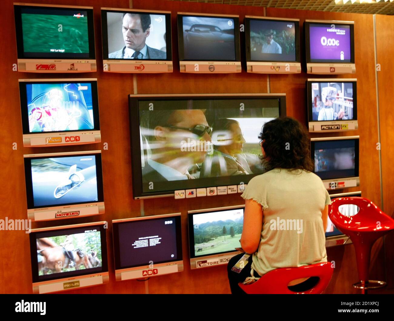 A visitor looks at television programmes during the annual MIPCOM television  programme market in Cannes, southeastern France, October 13, 2008. The  international film and programme market for TV, video, cable and satellite (
