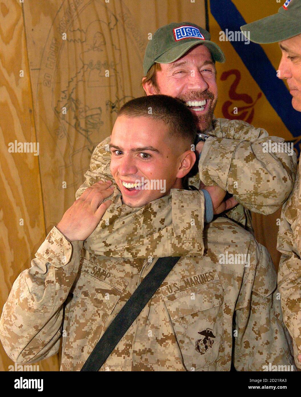 Actor and martial artist Chuck Norris playfully puts a choke hold on US