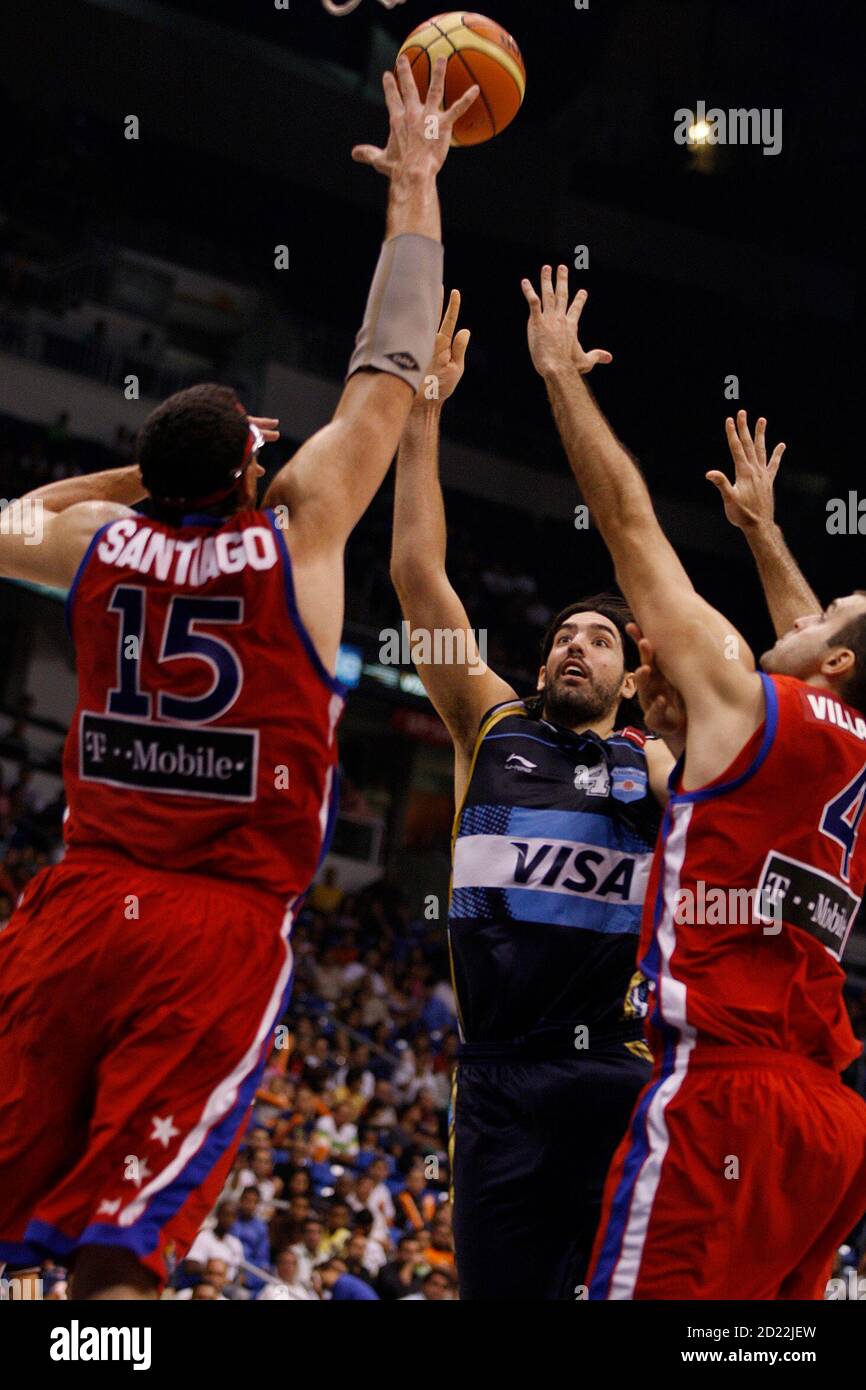 Argentina's Luis Scola goes for the basket against Puerto Rico's Daniel  Santiago (L) and Luis Villafane during their basketball game of the  Marchand Continental Championship Cup in San Juan, August 20, 2009.