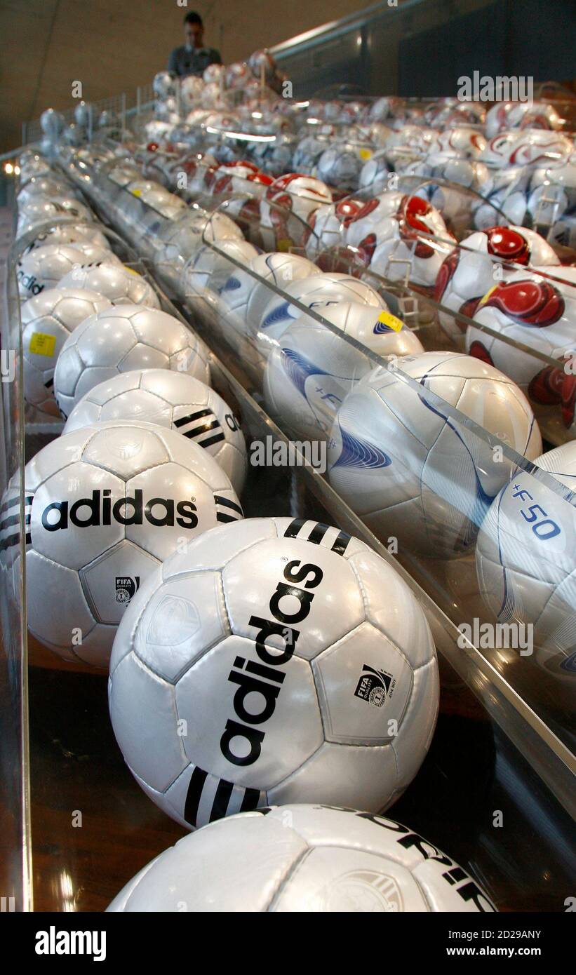 A employee of German sporting goods maker Adidas looks at soccer balls at  the company's factory outlet store in the northern Bavarian town of  Herzogenaurach, March 4, 2009. Adidas expects sales and