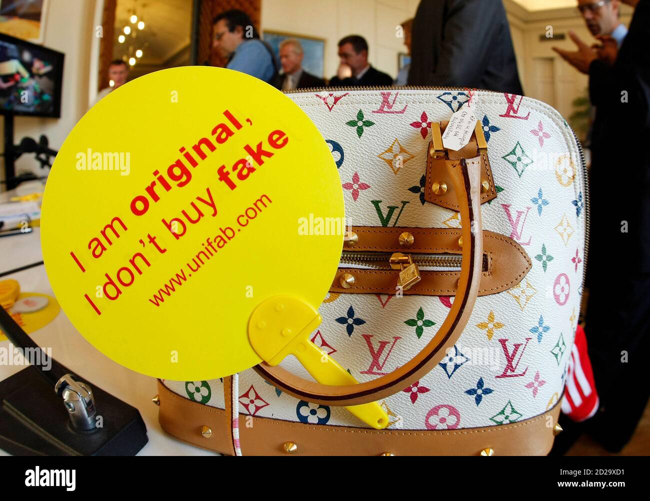 A campaign slogan, 'I am original, I don't buy fake' is displayed on a  counterfeit Louis Vuitton luxury handbag by French Customs officers before  a destruction operation in Cannes, southeastern France September