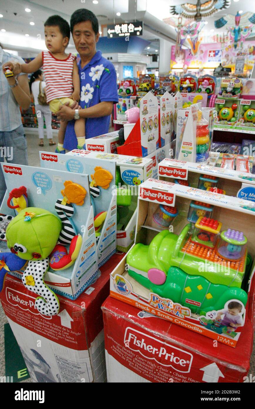 Shoppers walk past FisherPrice toys at a store in Beijing August 2