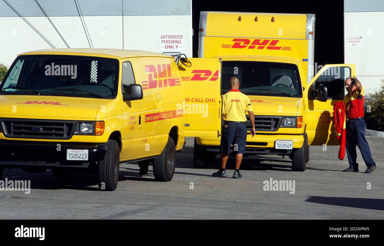 Two DHL couriers prepare to depart a DHL facility to begin deliveries in  Burbank, California November 10, 2008. Deutsche Post AG will slash 9,500  jobs and halt U.S. domestic services at its