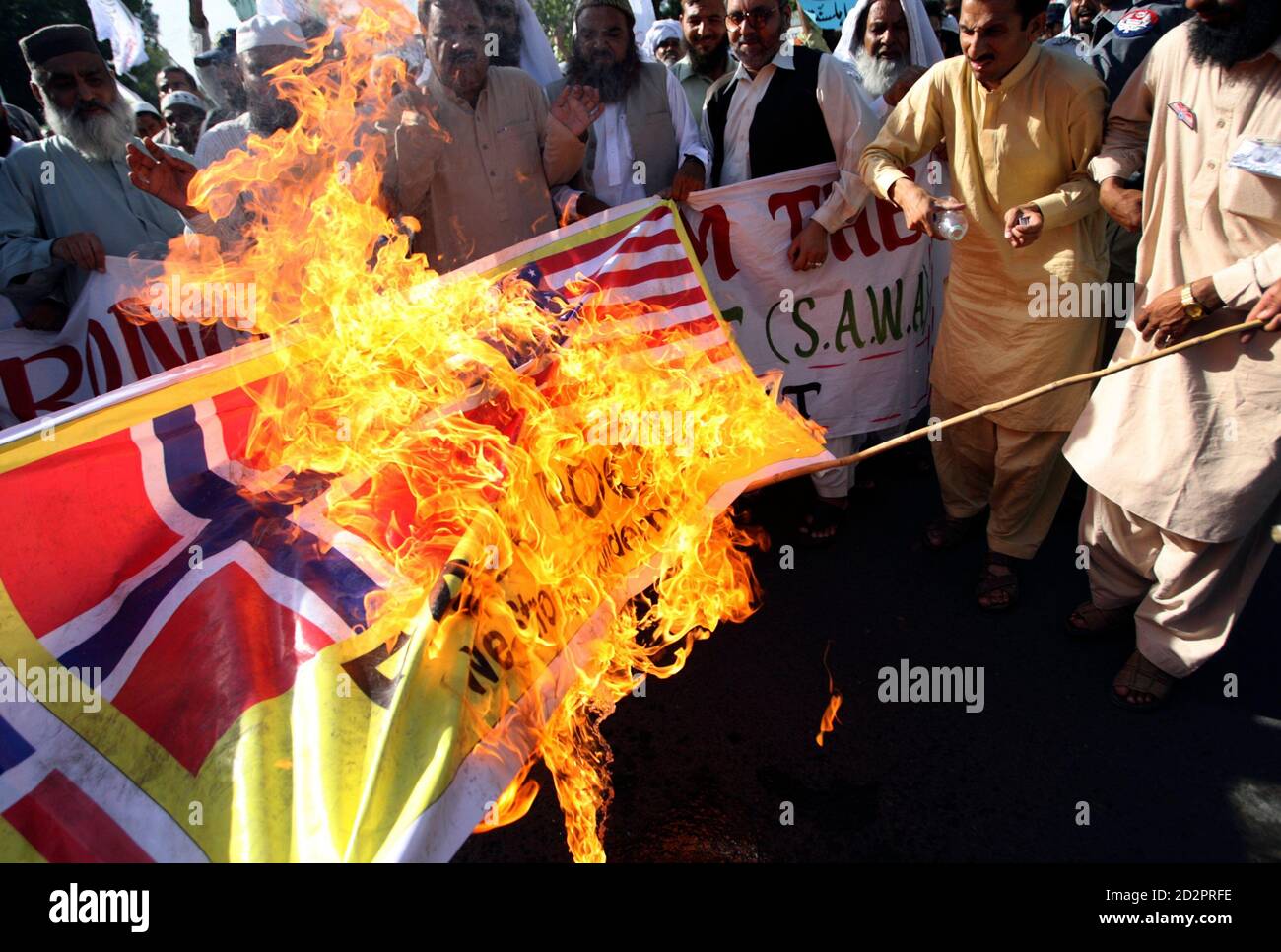 Pakistani Sunni Muslim burn U.S. and Norwegian flags during a protest in  Lahore on May 20, 2010, against an online competition to draw pictures of  Prophet Mohammad on Facebook which Muslims deem