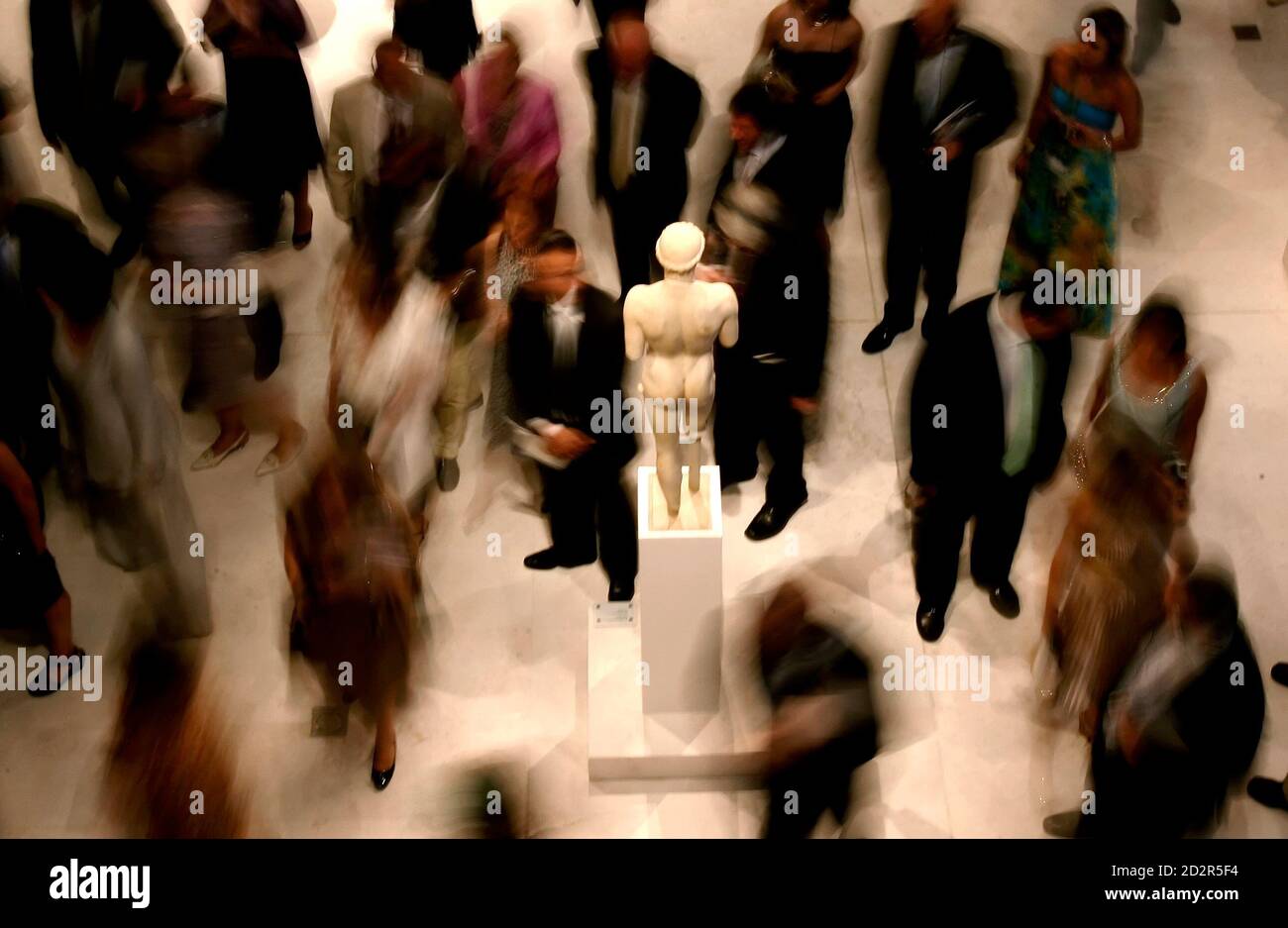 Visitors walk around the marble statue "Kritios boy" during the