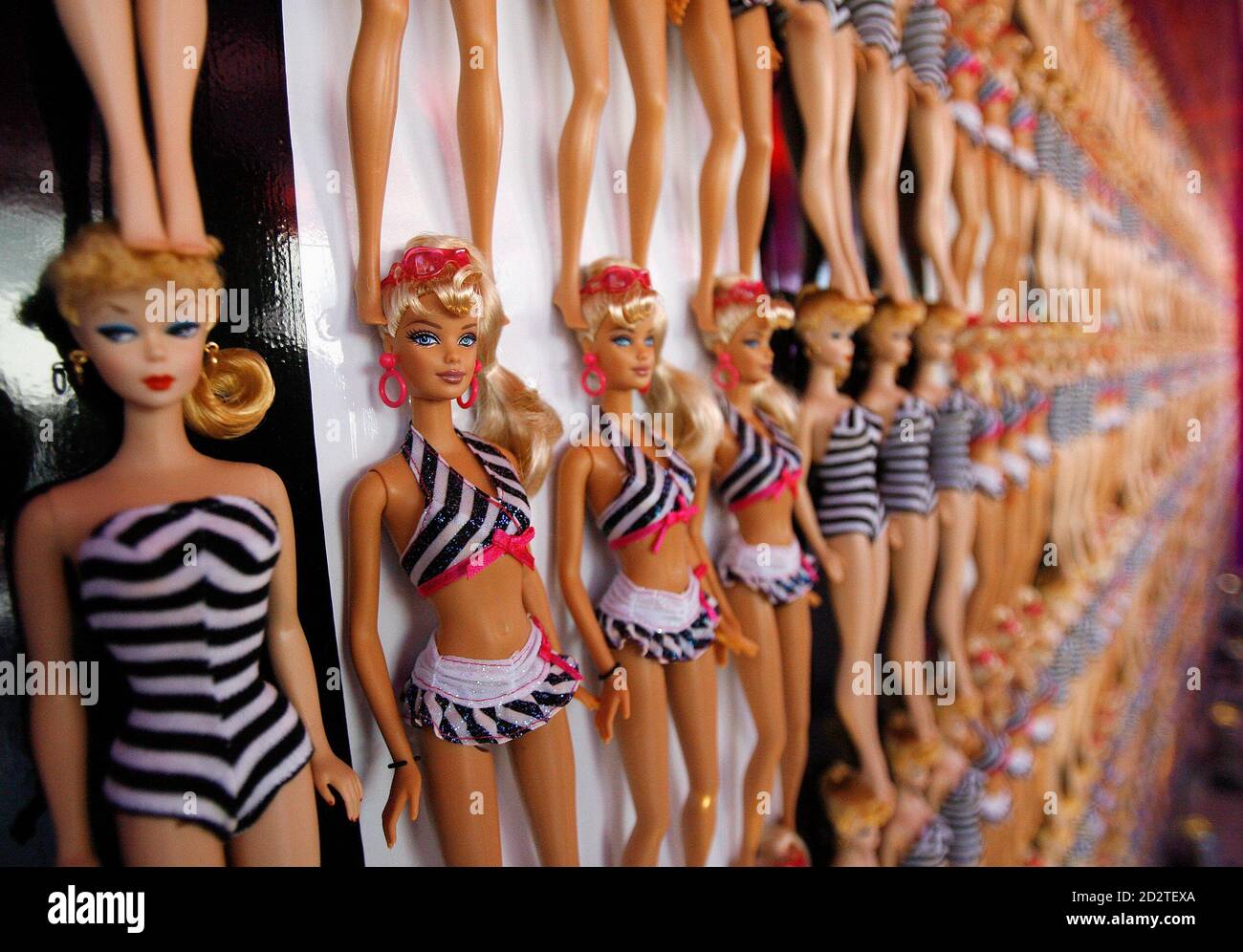 Barbie dolls are lined up on the wall at Barbie's 50th birthday party at  the Barbie real-life Malibu Dream House in Malibu, California March 9,  2009. REUTERS/Mario Anzuoni (UNITED STATES ENTERTAINMENT BUSINESS