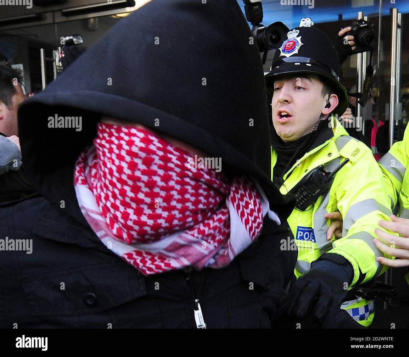 La policía impide que los manifestantes lleguen al Presidente Nacional de la Unión Nacional de estudiantes Aaron Porter, quien fue escoltado a la seguridad por la policía después de que fue rodeado por manifestantes en la manifestación de la NUS en Manchester hoy. Foto de stock