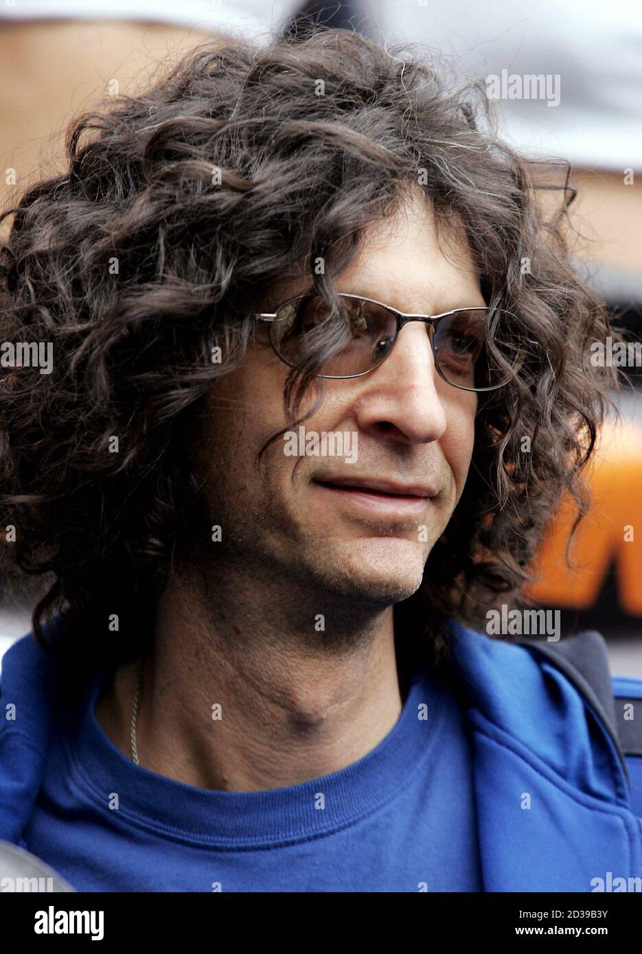 Flanked by strippers and personalities from his show, radio host Howard  Stern looks out over to thousands gathered in New York's Union Square where  500 Sirius satellite radios were given out, November