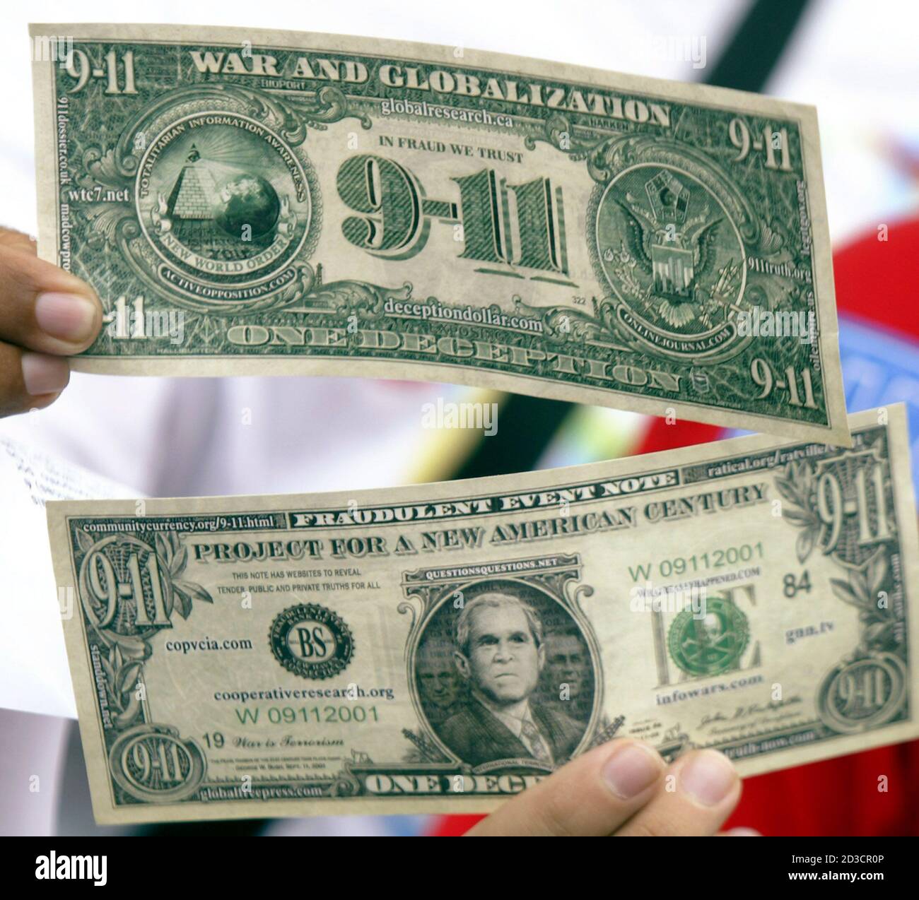 A Brazilian anti-war protester holds fake U.S. currency, modeled after the  dollar bill but showing an image of U.S. President George W. Bush and  referring to the September 11 attacks, during a