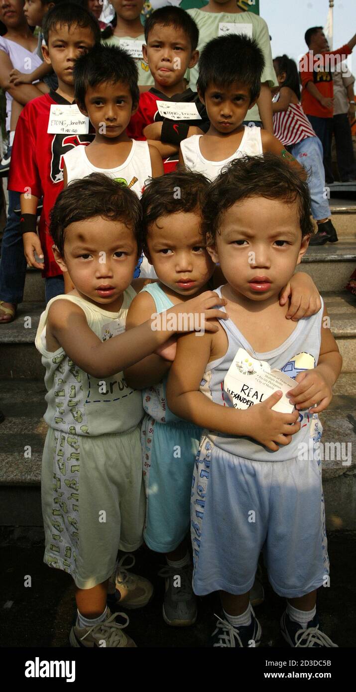 Filipino triplets pose in front of twins during the 2nd annual Festival of Twins  and Multiple Births in Manila. Filipino triplets pose in front of twins  during the 2nd annual Festival of