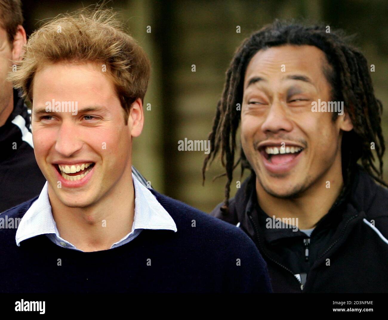 Britain's Prince William (L) laughs with captain of the All Blacks Tana Umaga at a public training session in Auckland July 4, 2005. [Prince William, who graduated recently from Scotland's St Andrews University, met the All Black team two days after they defeated the British and Irish Lions in Wellington and took an unbeatable 2-0 lead in the best-of-three test series.] Prince William is also performing official duties during his ten-day tour of New Zealand, his first official tour of a foreign country by himself. Foto de stock