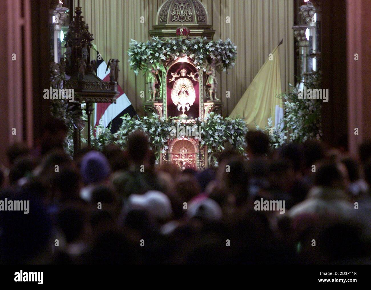 Costa Rican catholics look at statue of the Virgin of Los Angeles