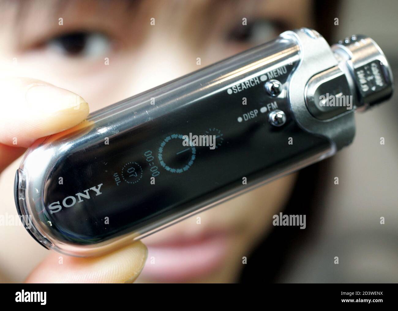 A woman holds Sony Corp's new Walkman portable music player NW-E507 in  Tokyo March 9, 2005. The new flash memory player is equipped with an  organic electro-luminescence (OLED) display and is capable