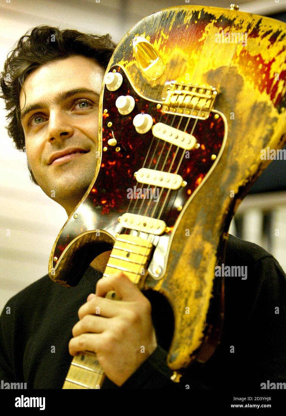 Dweezil Zappa, son of legendary rock musician [Frank] Zappa, holds up the  Fender Stratocaster guitar [that was owned by and burnt on stage by Jimi  Hendrix at the 1968 Miami Pop Festival,]