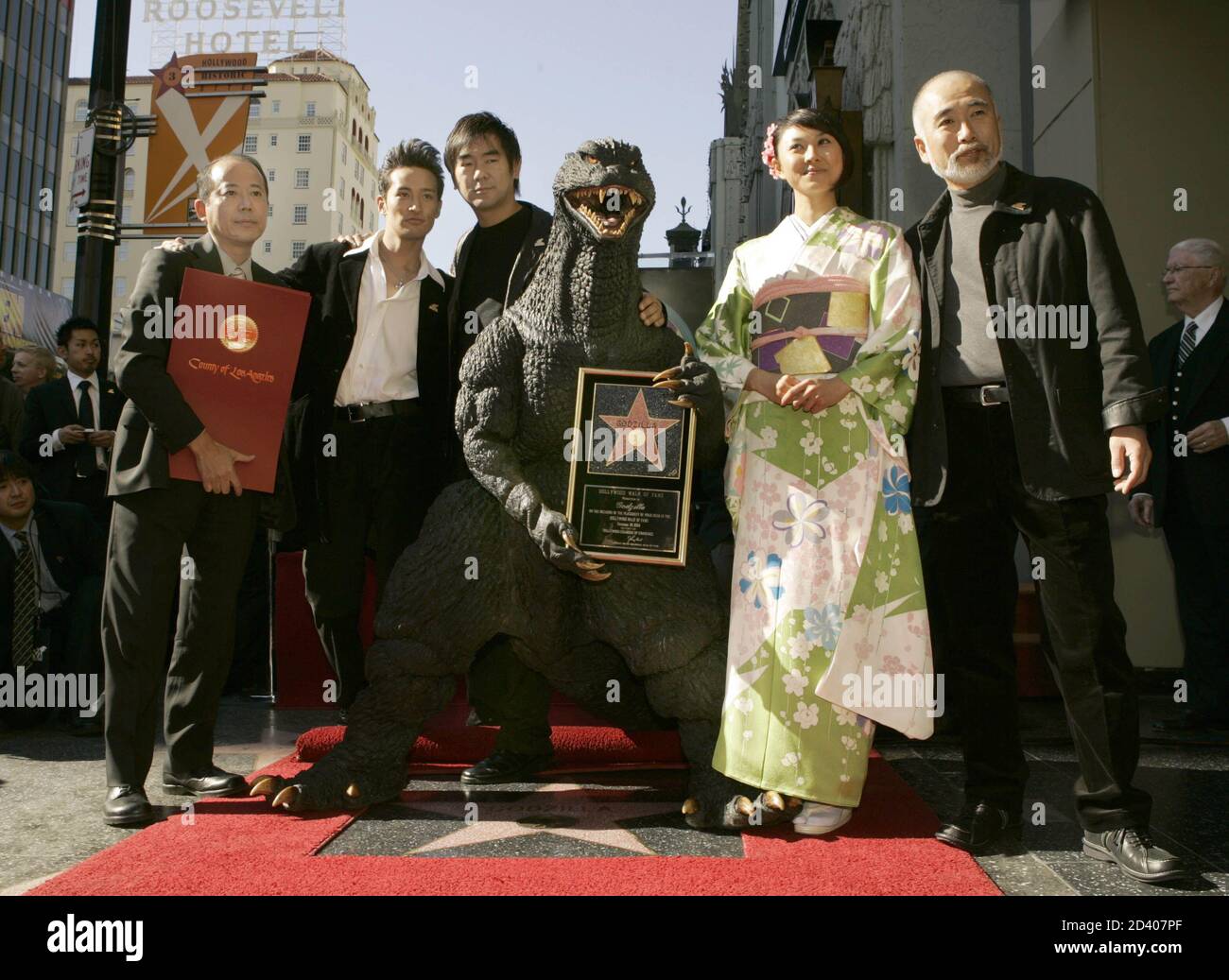 Film character "Godzilla" poses on the red carpet with Japanese actors Film character "Godzilla" poses on the red carpet with Japanese actors