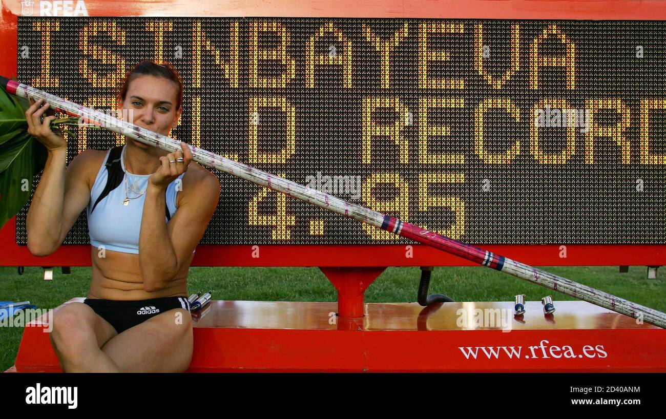 Russian pole vaulter Yelena Isinbayeva poses in front of a scoreboard