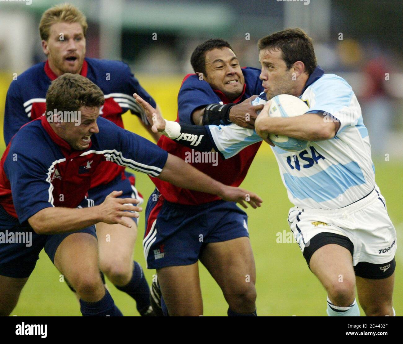 Diego Albanese (R), de la Argentina los Pumas, imputa a los Estados Unidos  la defensa de Kimball Kjar (L), Jone Naqica (C), y Jacob Waasdorp (L  atrás), en su partido de rugby