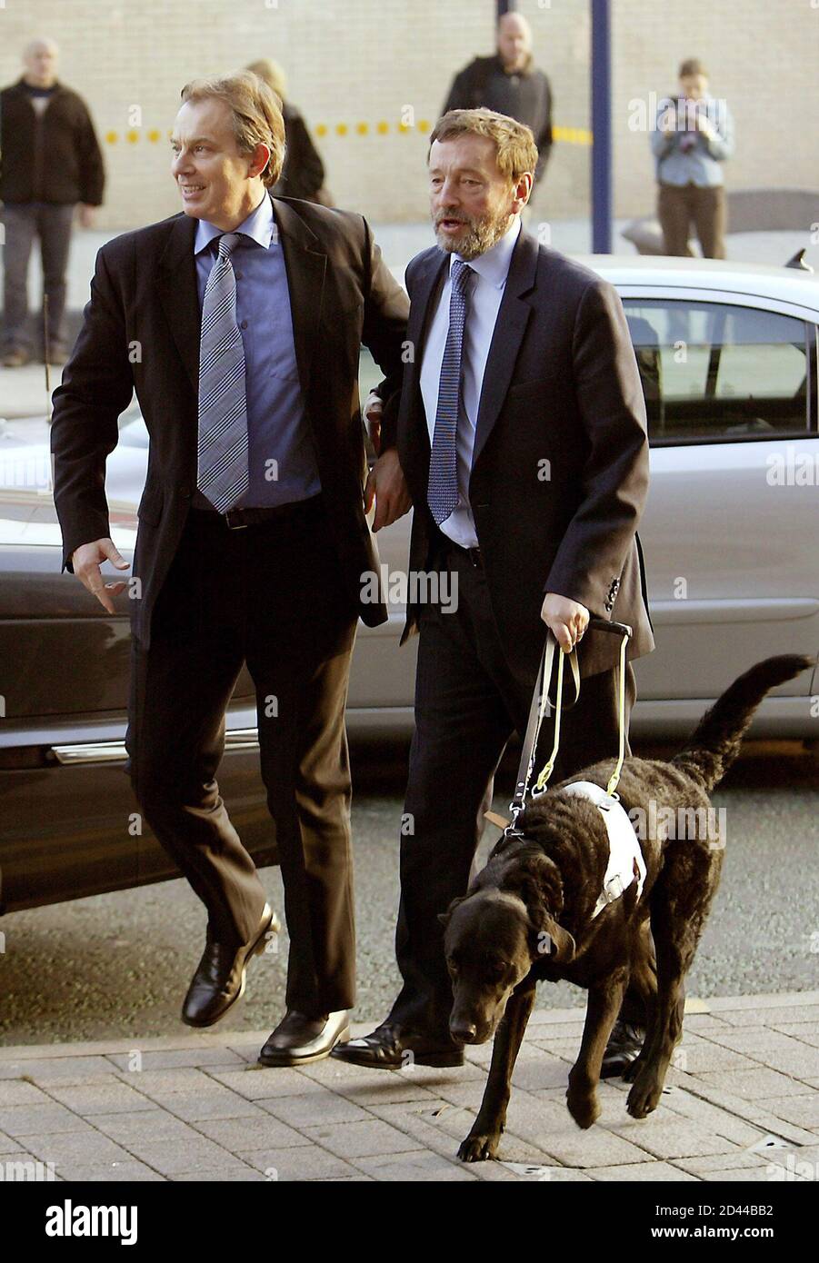 Britain's Prime Minister Tony Blair (L) and Home Secretary David Blunkett  arrive for a visit at the Purple Bar in Sheffield, northern England  December 9, 2004. Blunkett is facing several allegations linked