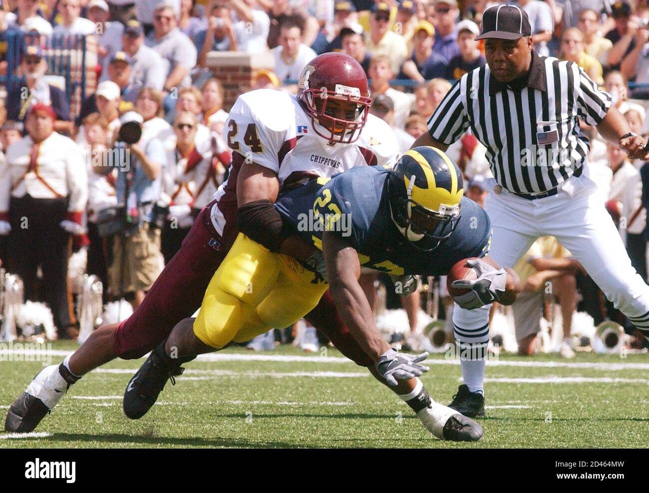 El regreso de la Universidad de Michigan Chris Perry (23) se sumerge en un touchdown con el Central Michigan James King (24) fallando en detenerlo en el segundo cuarto del juego en el Michigan Stadium en Ann Arbor, 30 de agosto de 2003. REUTERS/Rebecca Cook RC Foto de stock