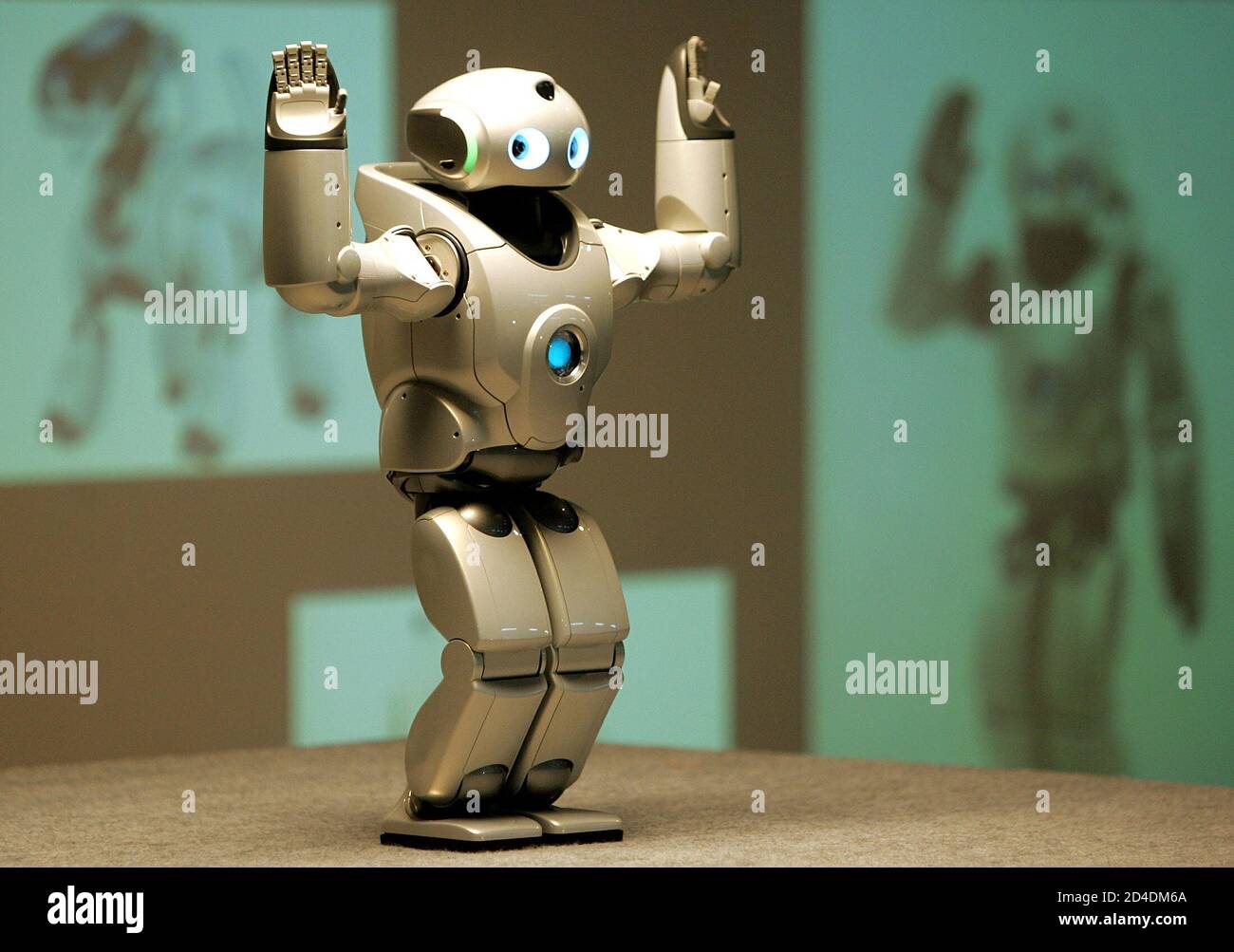 The QRIO, Sony Corp's small bipedal entertainment robot performs a dance  during a demonstration in a school in New Delhi October 26, 2004. QRIO has  been appointed by NFUAJ as the science