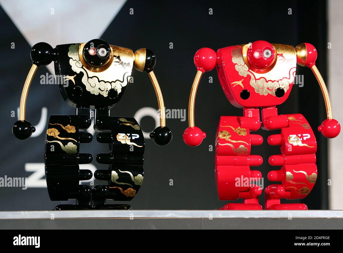 Humanoid robots "nuvo", painted in traditional Japanese lacquer, perform  during a demonstration at robot maker ZMP's office in Tokyo April 12, 2005.  The 39 centimetre-tall (15 inches) human-shaped walking robot, developed by