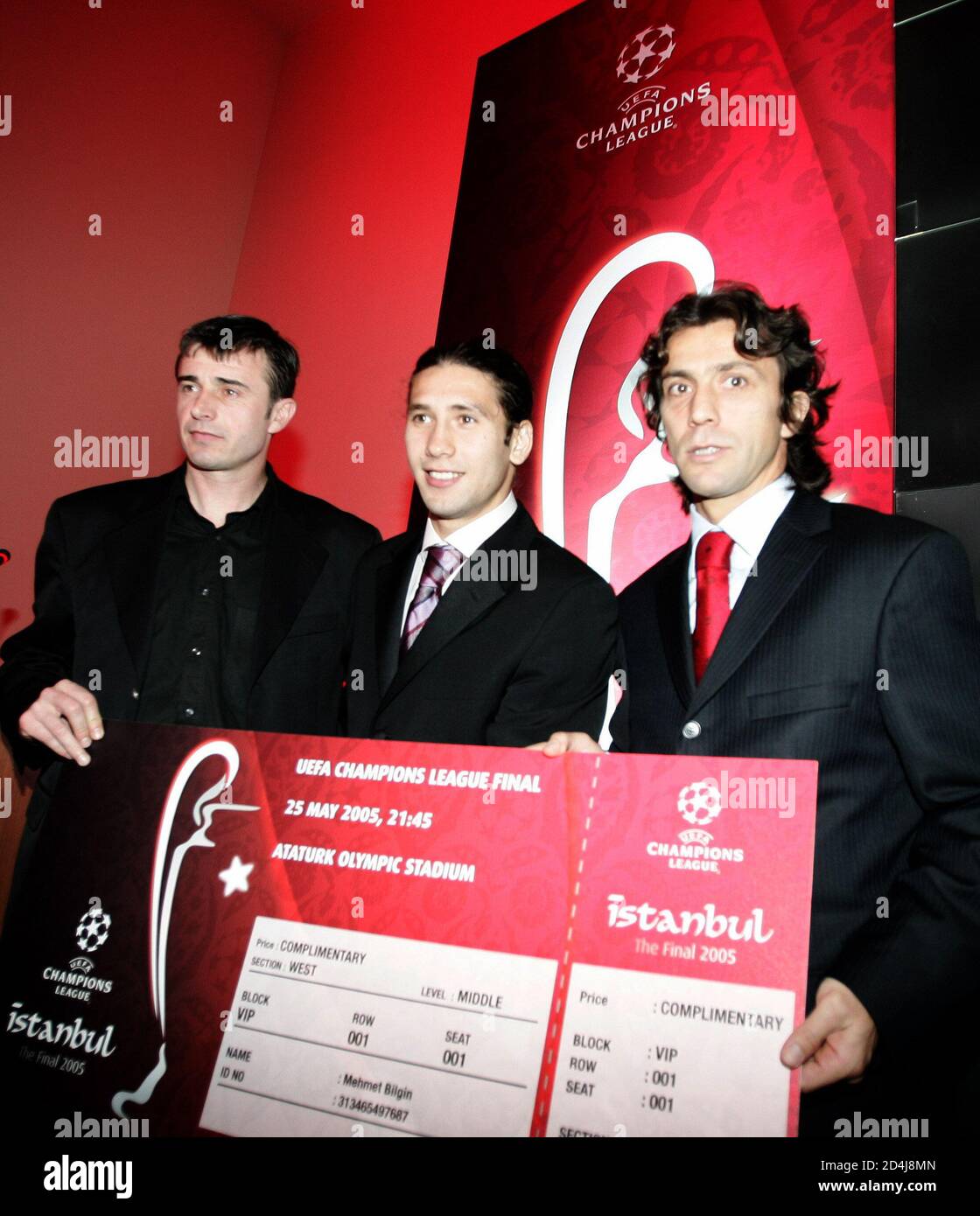 Turkish soccer club players Akbas, Yozgatli and Korkmaz hold a symbolic ticket of 2005 UEFA Champions League final in Istanbul. soccer club players Saffet Akbas (L) of Istanbulspor, Mehmet Yozgatli (C)