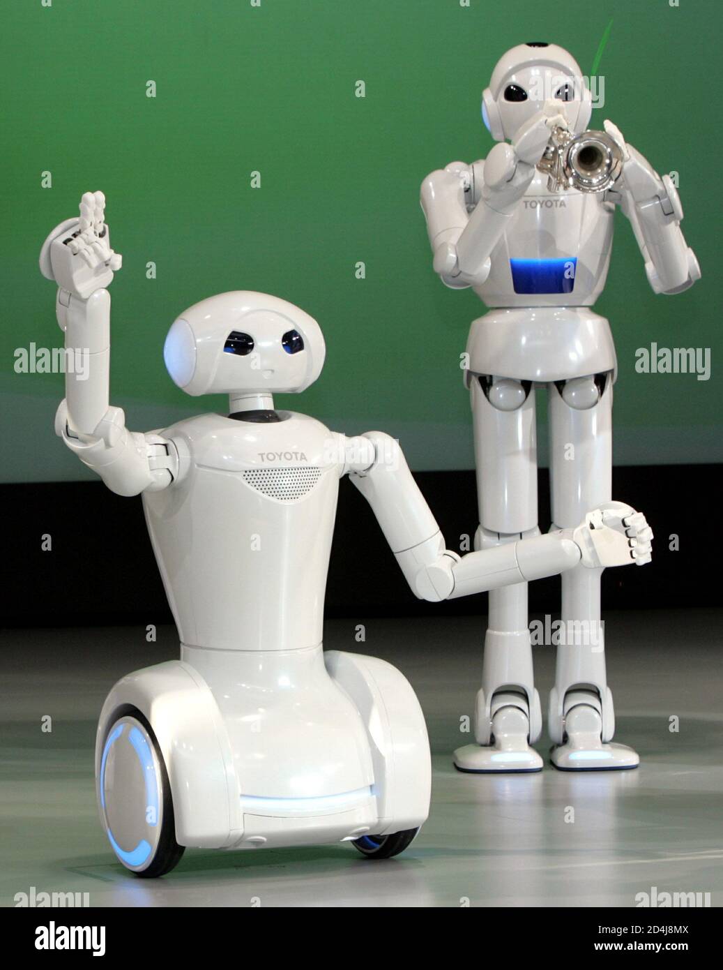 Toyota Motor Corp's new DJ (L) and music playing robot perform at the company's showroom in Tokyo December 3, 2004. The robots as part of a press preview for