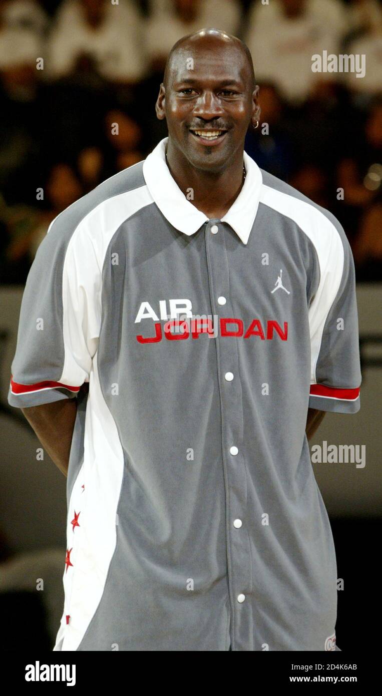La leyenda del baloncesto estadounidense Michael Jordan sonríe mientras se con estudiantes en Hong Kong el 21 de mayo de 2004. Jordania está en el territorio como parte de su viaje