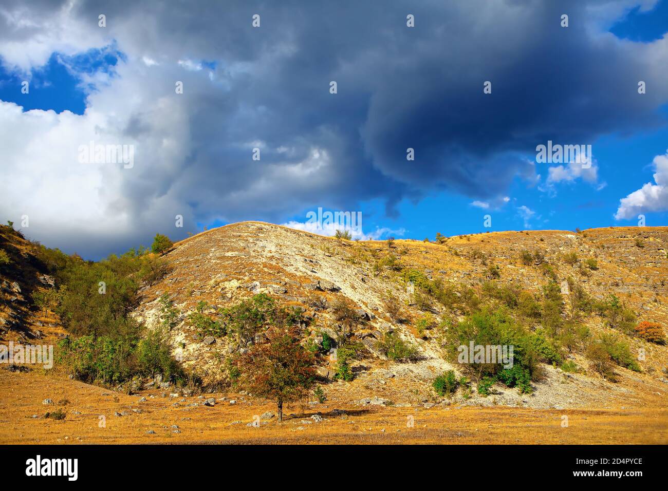 Nubes bajas sobre la colina. Paisaje de monte rocoso Foto de stock
